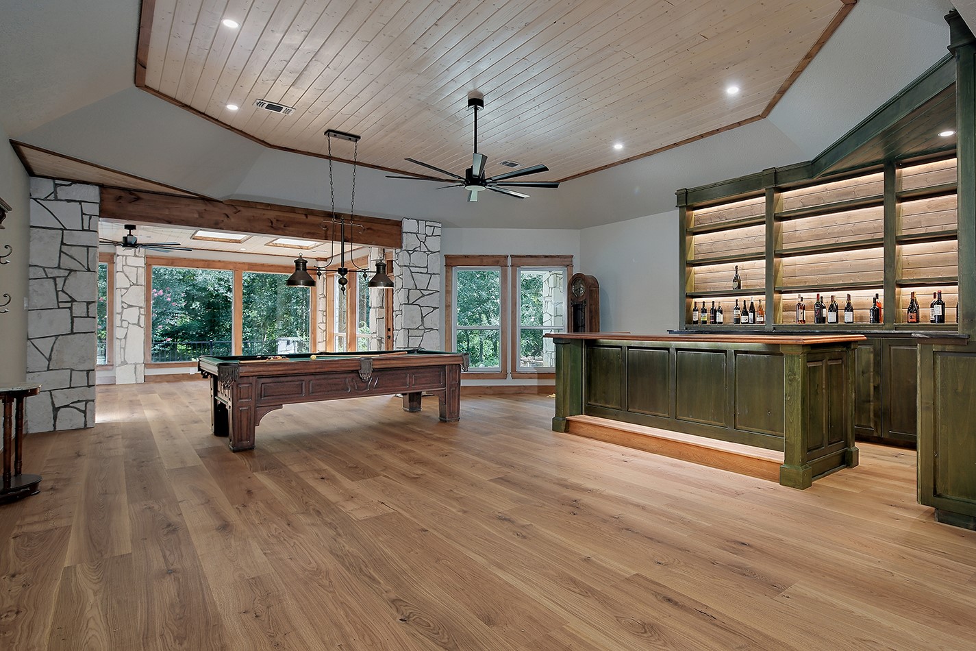 26442 McDonald Road Spring, TX 77380 - Photo 47 of 50 Original Photo: Game room with custom bar has stunning architectural features with stone columns and substantial wood beams.