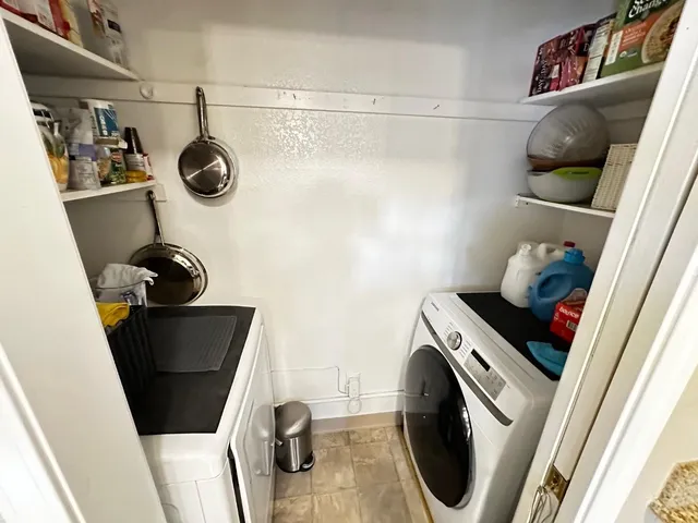 a bed sitting in a bedroom next to a window and a wooden floor