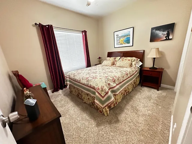 a bedroom with a bed and a window