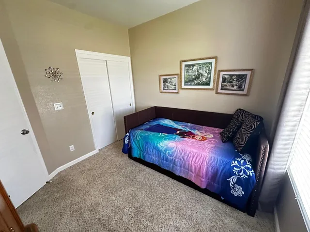 a bathroom with a granite countertop toilet sink and mirror