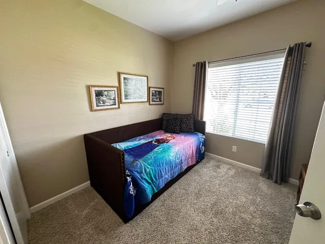 a living room with furniture window and a flat screen tv
