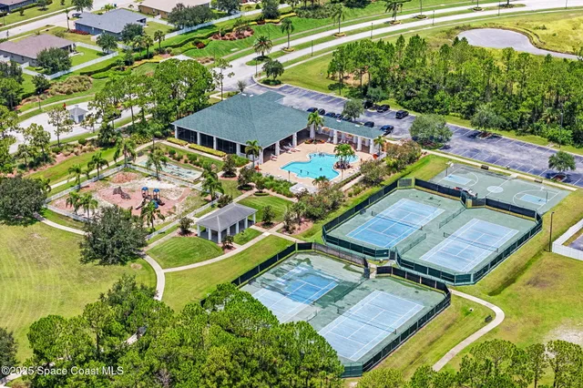 an aerial view of a house with swimming pool garden and patio