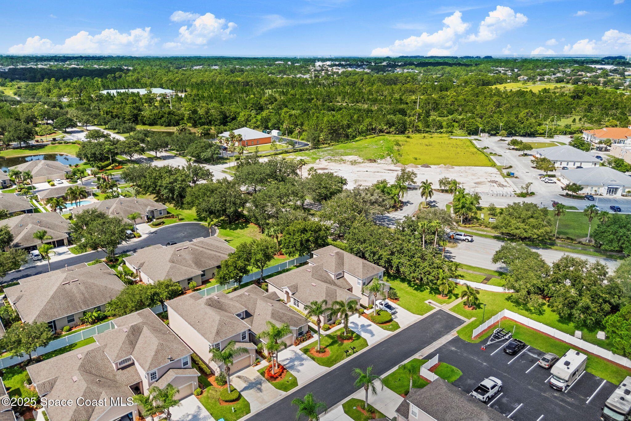 1910 Muirfield Way Southeast, Unit B Palm Bay, FL 32909 - Photo 33 of 34 an aerial view of residential houses with outdoor space and swimming pool