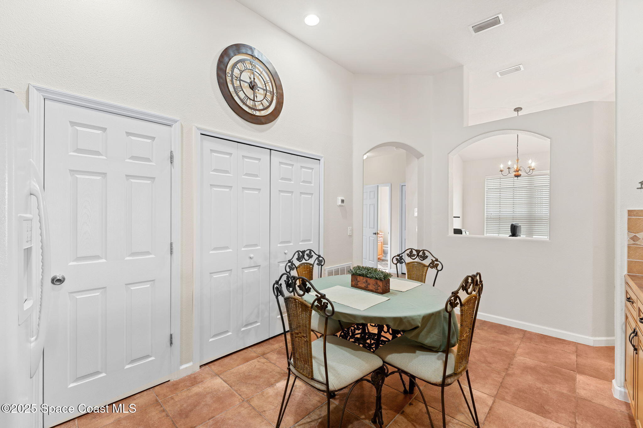 1910 Muirfield Way Southeast, Unit B Palm Bay, FL 32909 - Photo 10 of 34 a view of a dining room with furniture and a large window