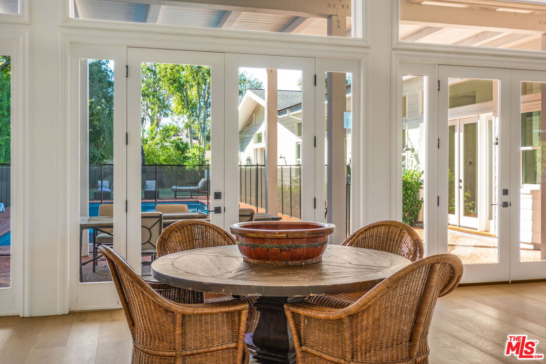 9669 Oak Pass Road Beverly Hills, CA 90210 - Photo 9 of 37 a dining room with furniture and wooden floor