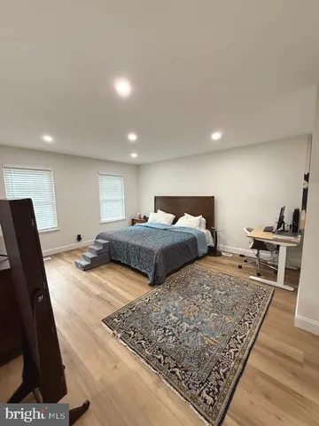 a bedroom with double bed and a couch