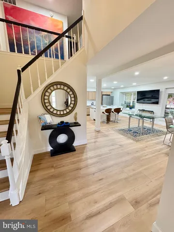 a view of a living room and a kitchen with furniture staircase