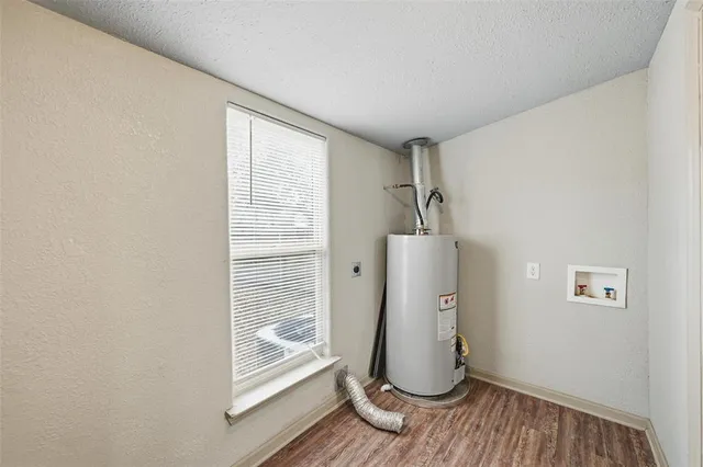 a view of room with wooden floor and stairs