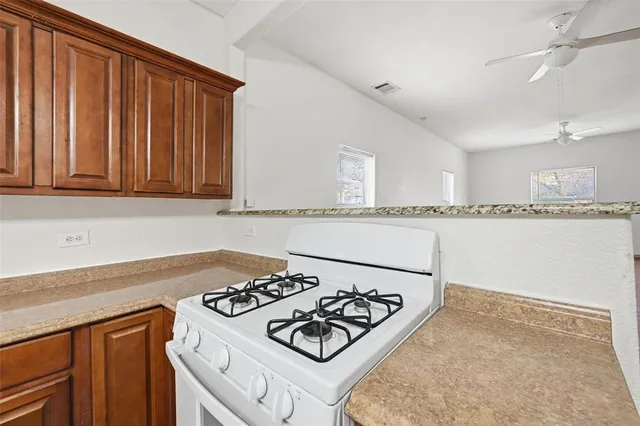 a kitchen with a stove and a refrigerator