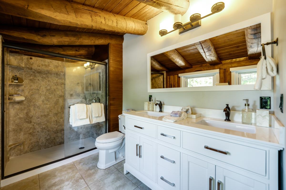 10734 Chickwick Reach Truckee, CA 96161 - Photo 9 of 21 a bathroom with a granite countertop sink a toilet and shower