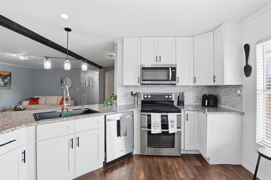 952 Gallilee Loop Lake City, FL 32024 - Photo 14 of 60 a kitchen with white cabinets and appliances
