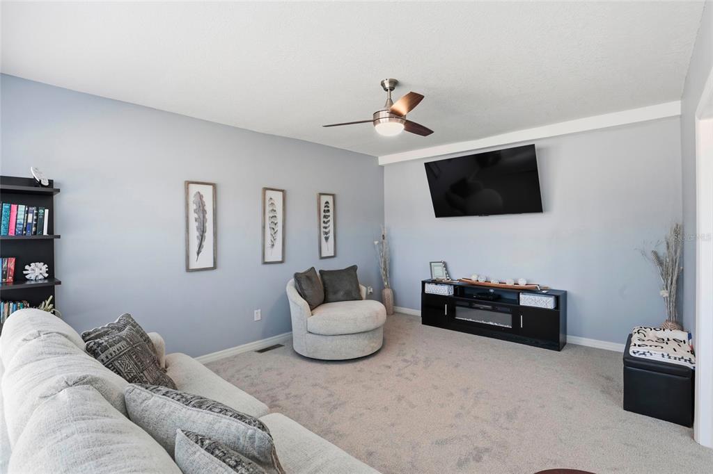 952 Gallilee Loop Lake City, FL 32024 - Photo 23 of 60 a living room with furniture and a flat screen tv
