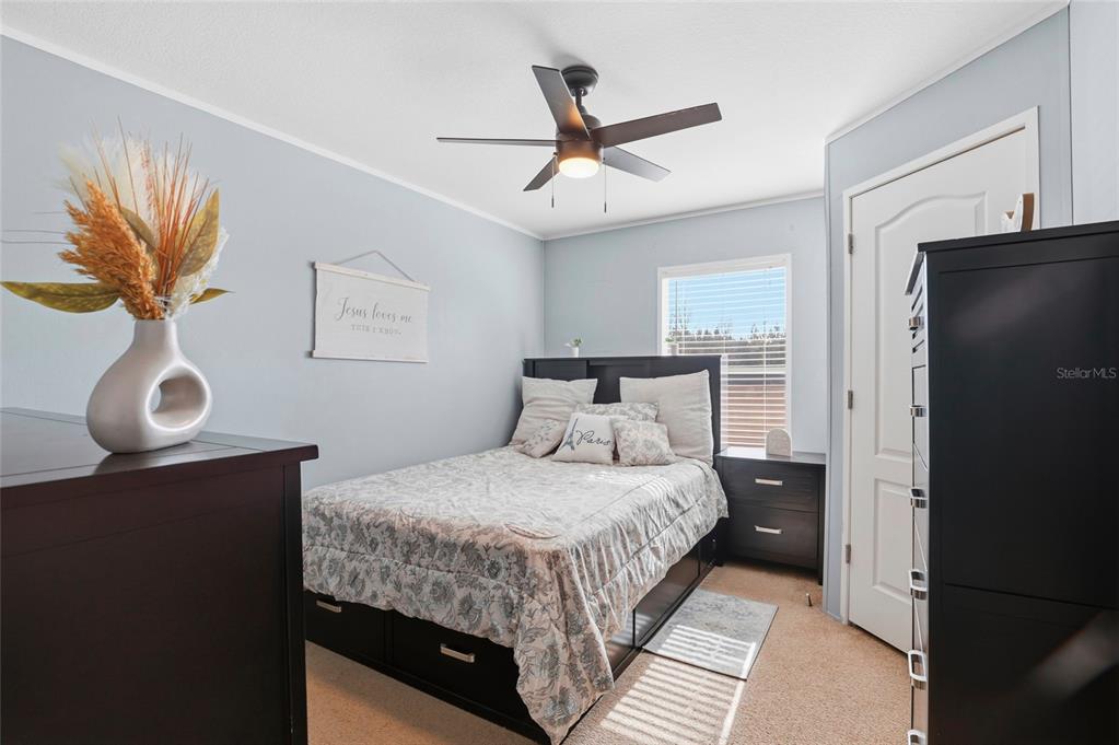 952 Gallilee Loop Lake City, FL 32024 - Photo 27 of 60 a bedroom with a bed and a chandelier