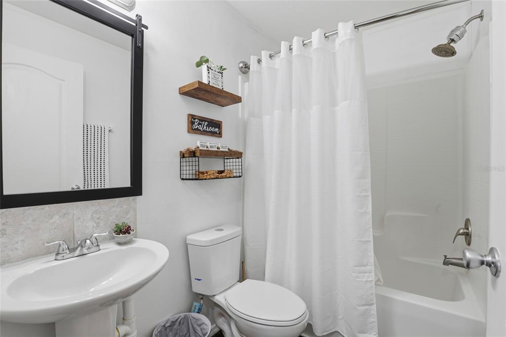 952 Gallilee Loop Lake City, FL 32024 - Photo 30 of 60 a bathroom with a sink a toilet and a bathtub