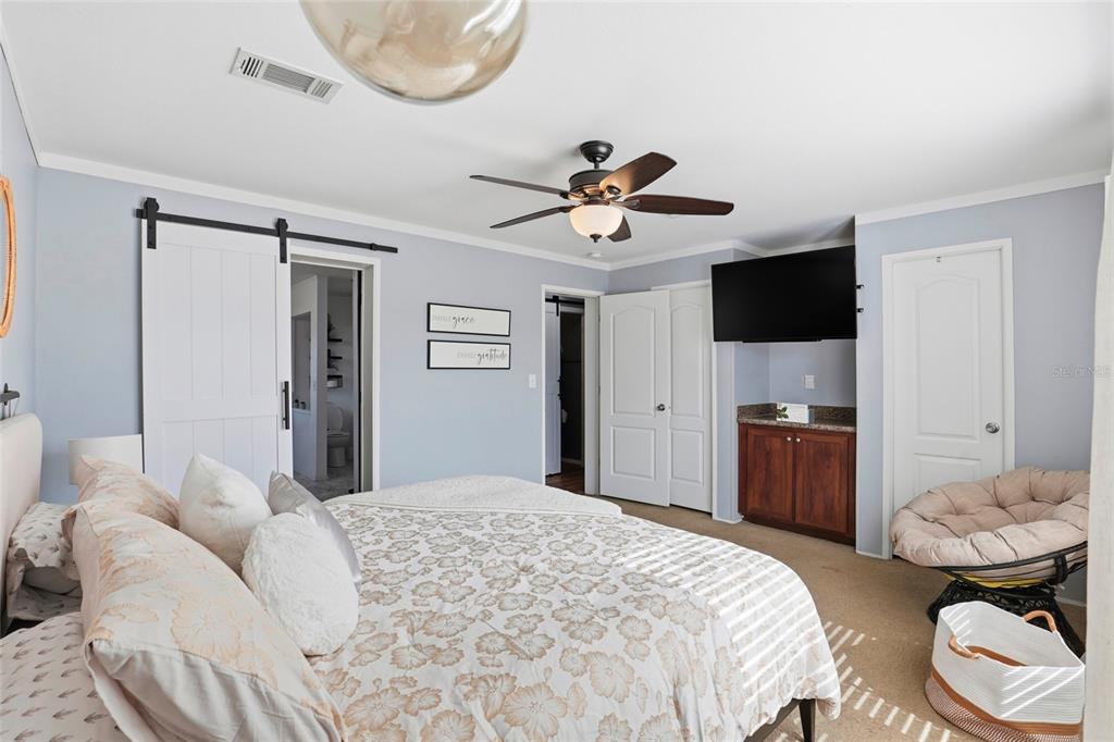 952 Gallilee Loop Lake City, FL 32024 - Photo 32 of 60 a bedroom with a bed and a chandelier