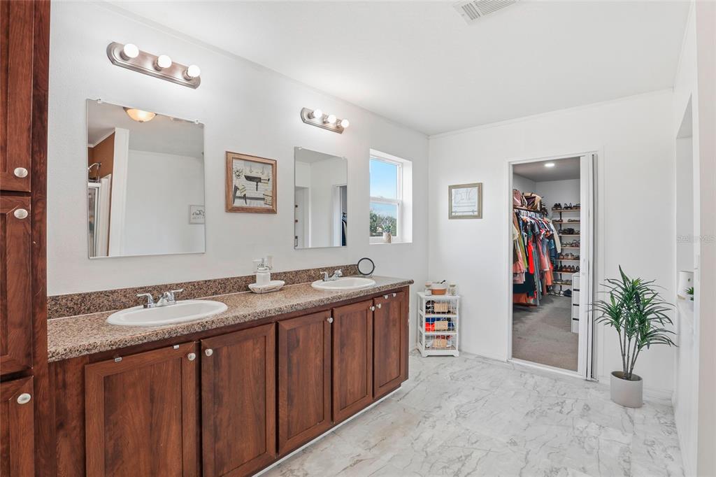 952 Gallilee Loop Lake City, FL 32024 - Photo 36 of 60 a bathroom with a granite countertop sink a mirror and a shower