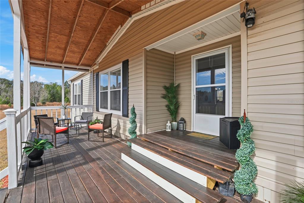 952 Gallilee Loop Lake City, FL 32024 - Photo 4 of 60 a roof deck with wooden floor and outdoor seating