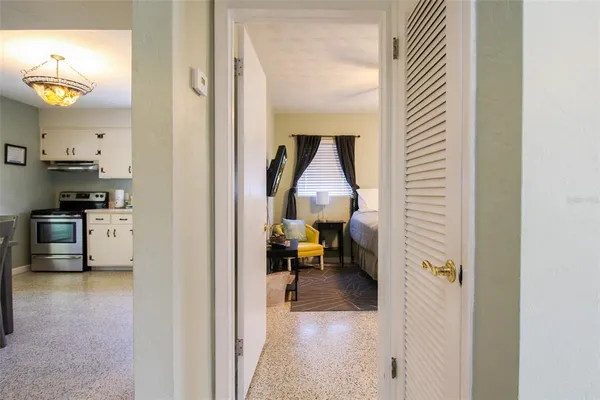 a bedroom with a bed and a flat screen tv