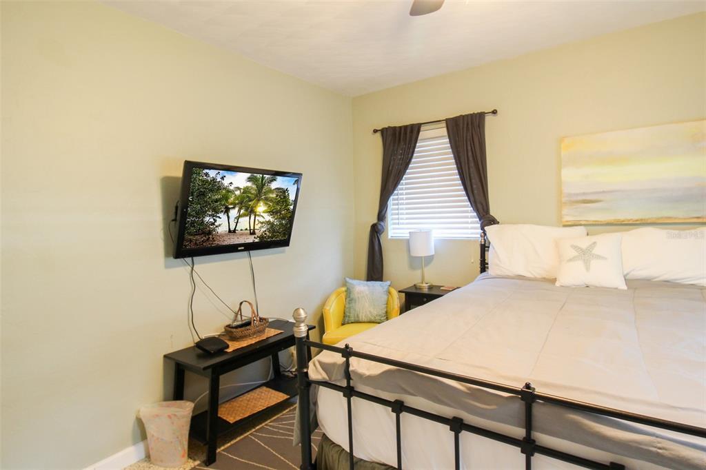 Undisclosed Address Venice, FL 34285 - Photo 17 of 63 a bedroom with a bed and a flat screen tv