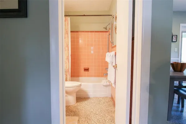a living room with patio furniture and a potted plant