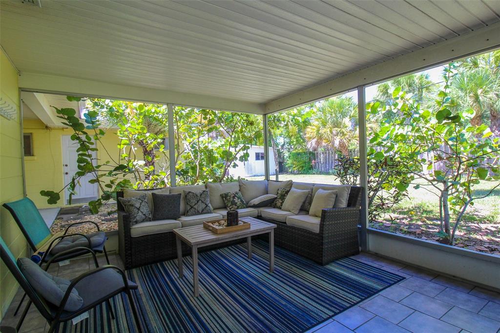 Undisclosed Address Venice, FL 34285 - Photo 22 of 63 a living room with patio furniture and a potted plant