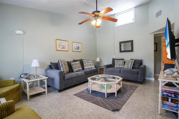 a living room with furniture a rug and a chandelier