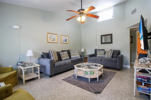 a living room with furniture a rug and a chandelier