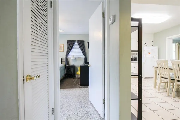 a bedroom with furniture and a large window