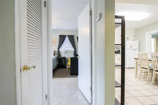 a bedroom with furniture and a large window