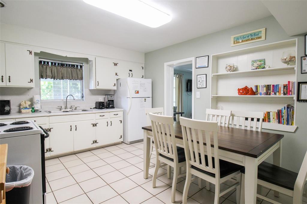 Undisclosed Address Venice, FL 34285 - Photo 46 of 63 a kitchen with stainless steel appliances a white table chairs and a refrigerator