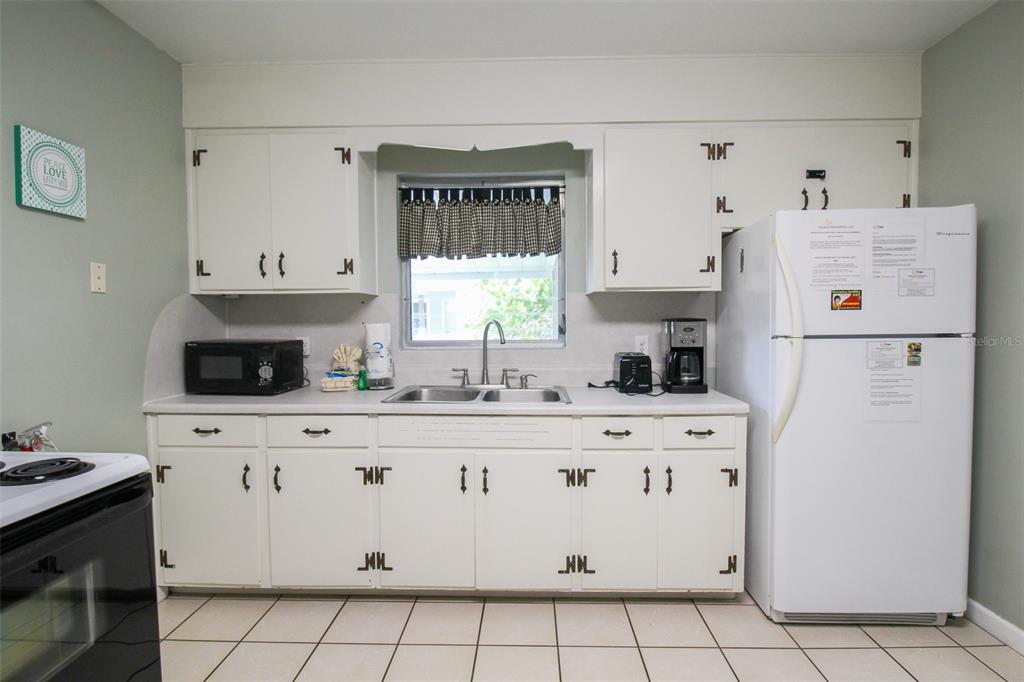 Undisclosed Address Venice, FL 34285 - Photo 47 of 63 a kitchen with white cabinets a refrigerator and a stove