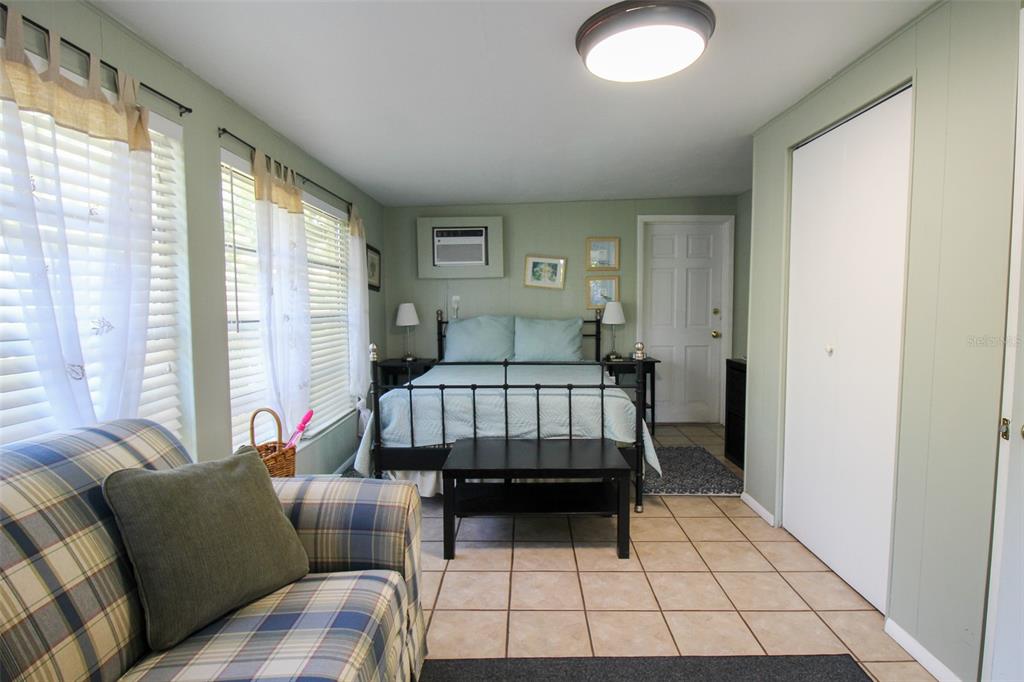 Undisclosed Address Venice, FL 34285 - Photo 52 of 63 a bedroom with furniture and a large window