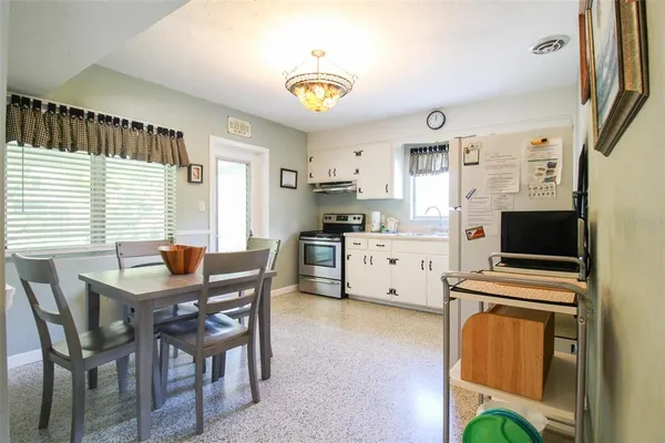 a kitchen with stainless steel appliances a stove a sink and a refrigerator