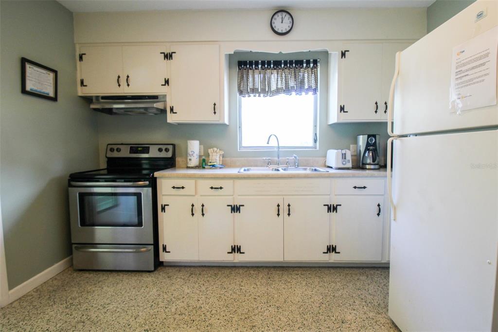 Undisclosed Address Venice, FL 34285 - Photo 10 of 63 a kitchen with stainless steel appliances a stove a sink and a refrigerator