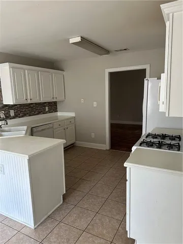 a kitchen with sink a stove and refrigerator