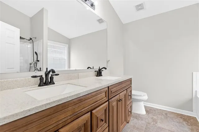 a bathroom with a sink a toilet and a mirror