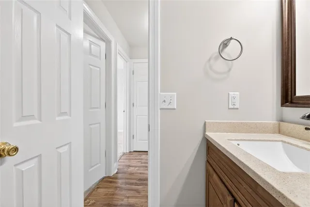 an empty room with a chandelier fan and windows