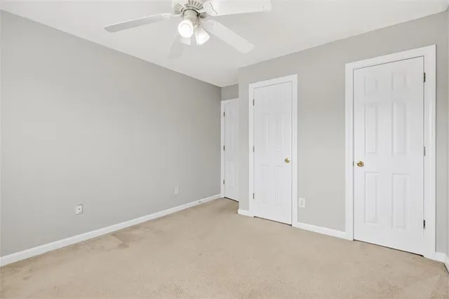 a view of a hallway with stairs and wooden floor