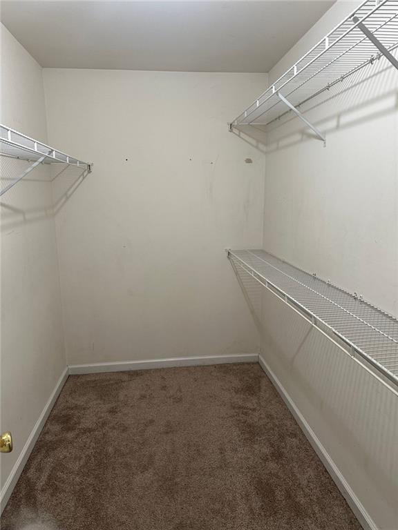 5630 Saltcreek PIace Northeast Sugar Hill, GA 30518 - Photo 7 of 10 a view of a room with racks on the wall