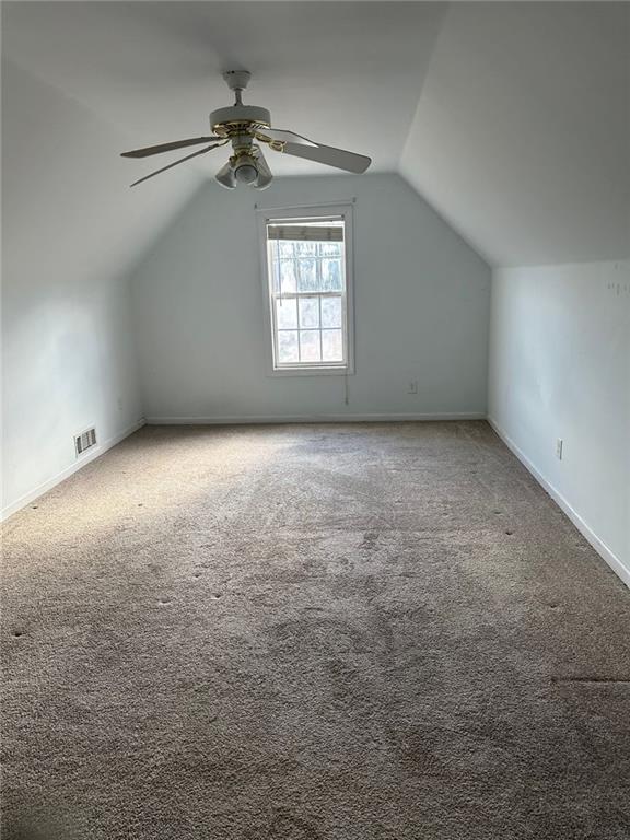 5630 Saltcreek PIace Northeast Sugar Hill, GA 30518 - Photo 8 of 10 an empty room with a chandelier fan and windows
