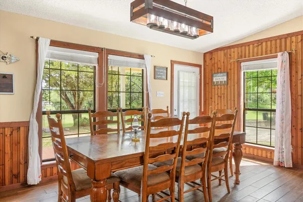 a view of a dining room with furniture window and wooden floor