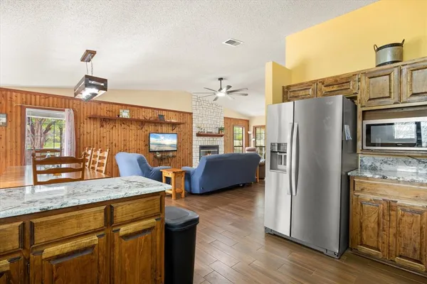 a kitchen with stainless steel appliances granite countertop a refrigerator and a sink