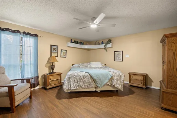 a spacious bedroom with a bed couch and a window