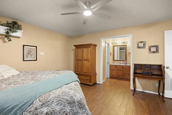 a bedroom with a bed and a refrigerator