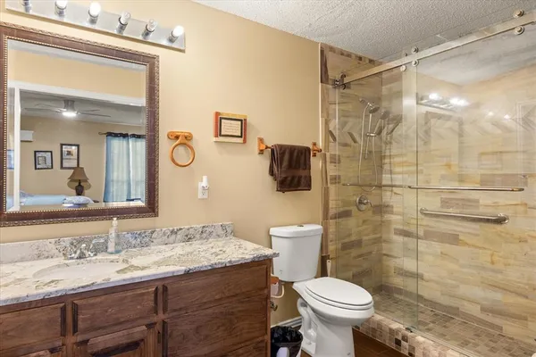 a bathroom with a sink toilet and shower