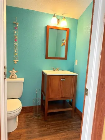 a bathroom with a toilet a sink and mirror