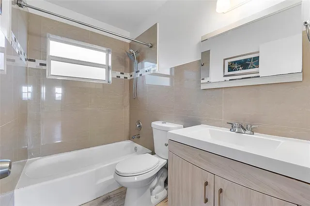 a bathroom with a sink mirror vanity and toilet