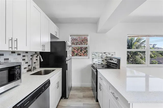 a kitchen with a refrigerator stove and sink