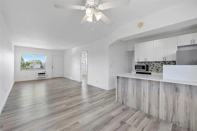 a view of kitchen with sink and wooden floor
