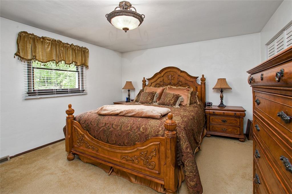 350 Apache Lane Apollo, PA 15613 - Photo 24 of 34 a bedroom with a bed and a chandelier